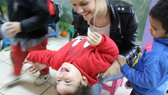 Volunteers and children understanding.