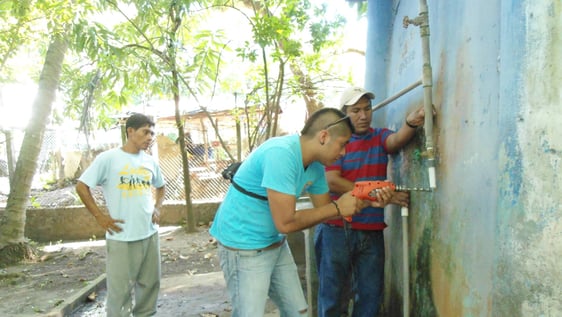 Volunteer installing a purification system
