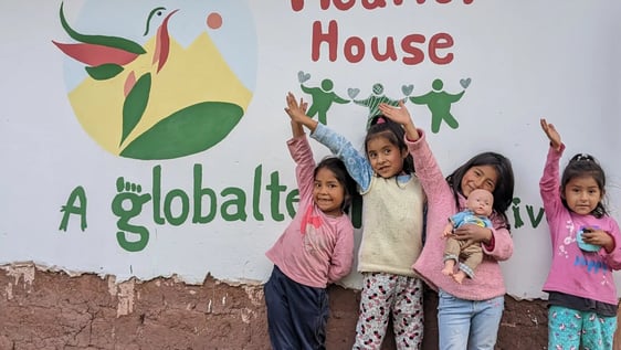 Children at the Picaflor House sign, Globalteer’s after-school project in Cusco, Peru