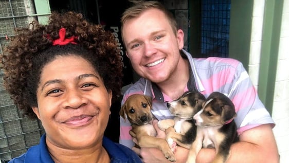 volunteers holding dogs
