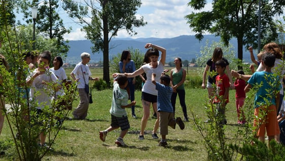Volunteers dancing with the children