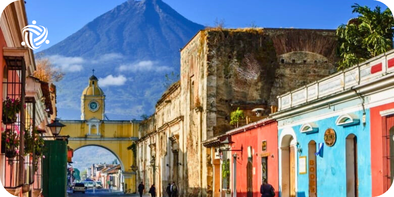 colorful buildings in front of a mountain in guatemala
