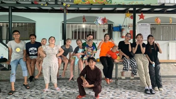 Volunteers, staff and children at a centre in Ho Chi Minh City