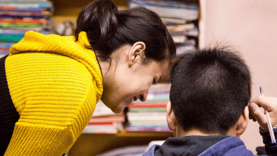 Volunteers and children understanding.