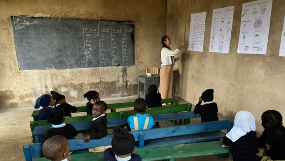 Volunteer is teaching in a primary  school.