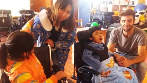 Volunteers with a pupil at the special needs school in Cusco