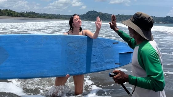volunteers learning surf in a sea turtle project