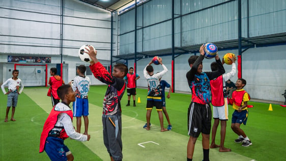 Volunteer coaching football with children in Galle, southern Sri Lanka