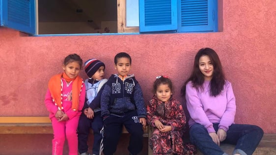 The volunteer Ellen with some of the kids she is entertaining in one of our childcare project in Rabat's Neighborhood. 