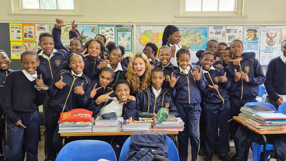 Volunteer supporting a teacher in a primary school classroom in Cape Town, South Africa